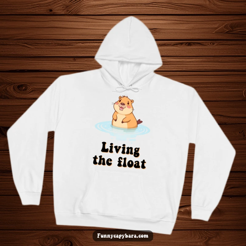 Funny hoodie featuring a cheerful capybara floating peacefully on its back in stylized water, offering ultimate cozy relaxation.