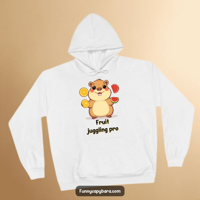 Funny hoodie depicting a happy capybara with wide eyes juggling vibrant fruit slices, offering cozy and playful vibes.