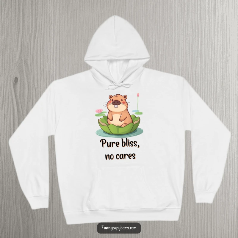 Funny hoodie showing a capybara with a blissful smile, serenely floating atop a giant lily pad.